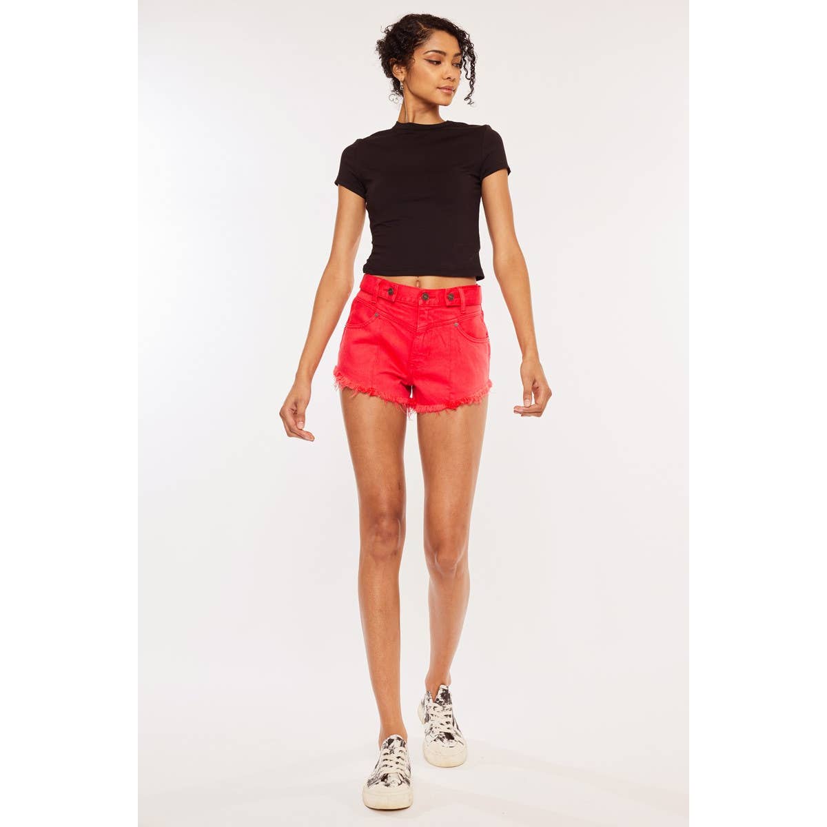 zoomed out front view of Kan Can USA high rise coral red shorts with frayed hem and button accent
