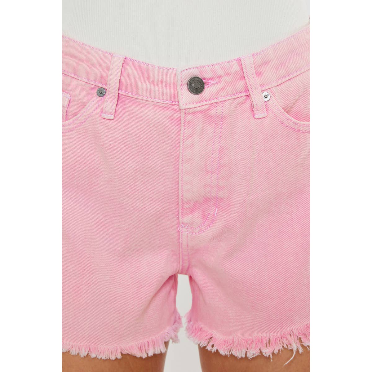 zoomed in front view of Kan Can USA pink high rise denim shorts with frayed hem