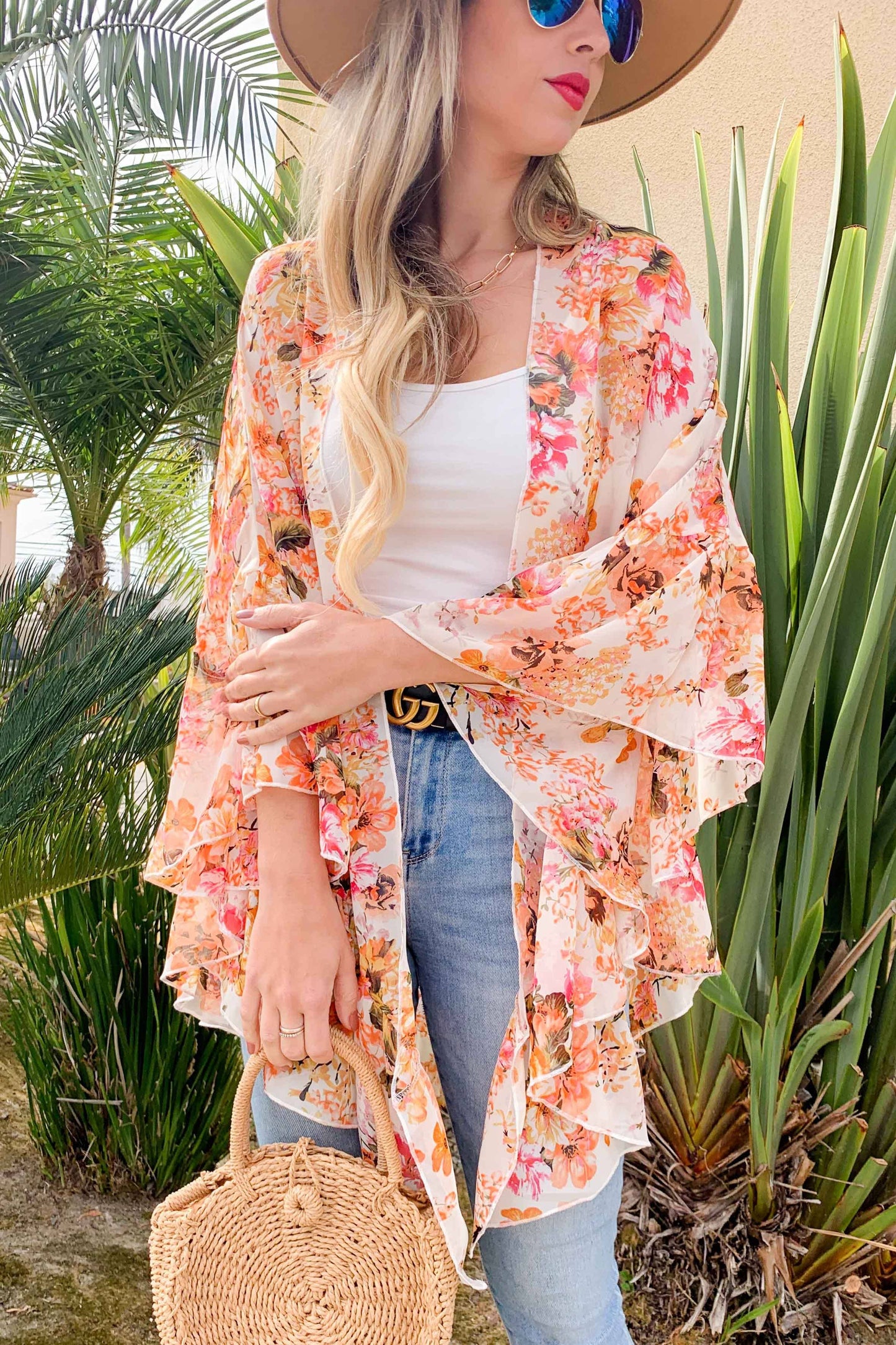 arm crossed view of Floral print ruffled sleeve chiffon kimono cardigan with limited stock