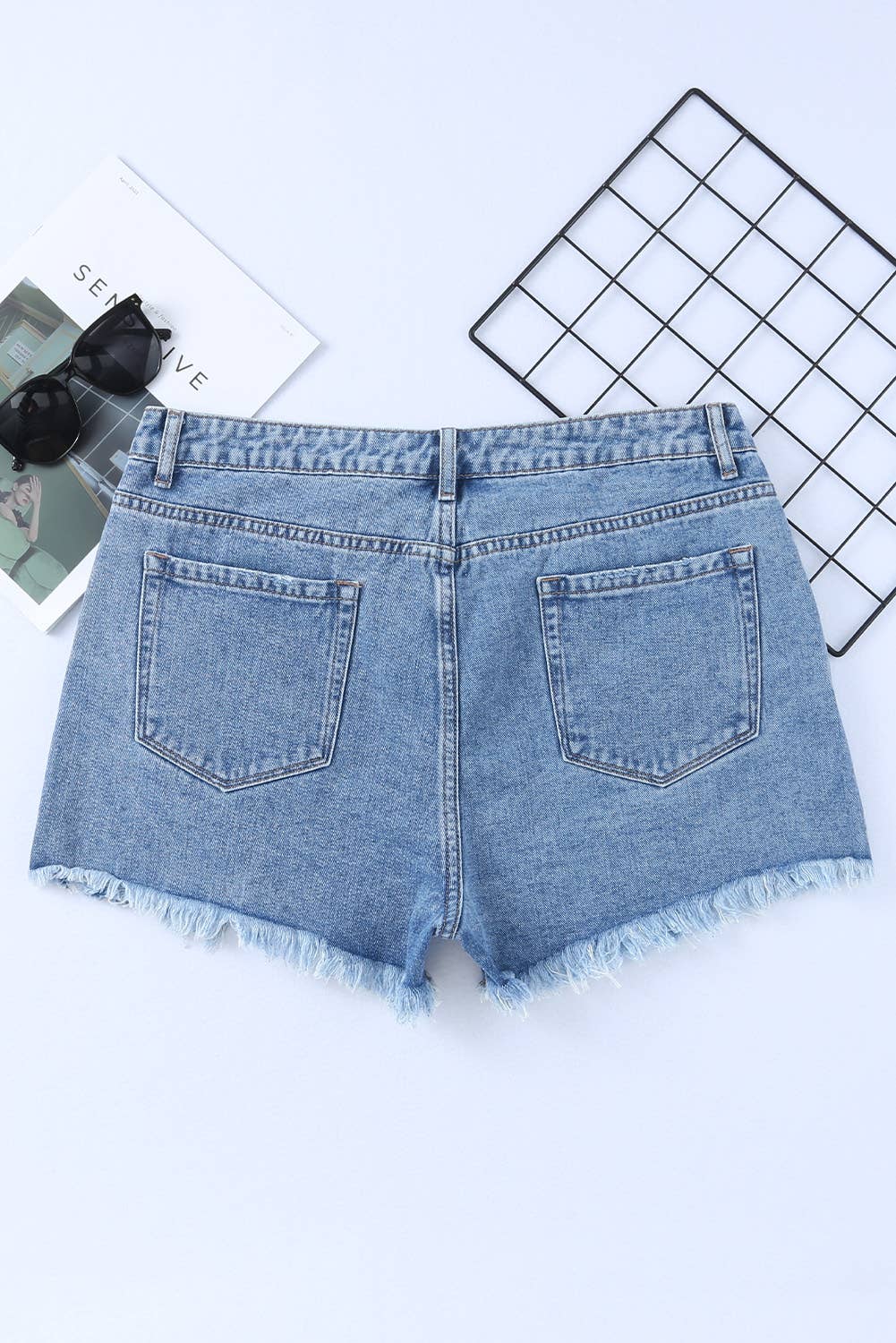 back view of High Rise Crossover Waist Denim Shorts with a fashionable crossover waist design, ideal for a sexy and stylish beach vacation.