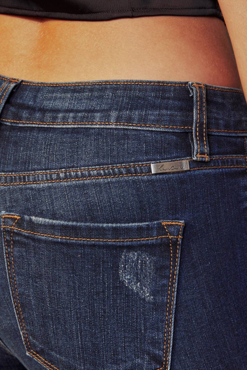 pocket detail of Kan Can Mid Rise Leopard Patch Super Skinny Jeans in Dark Wash with leopard patch details, 5-pocket design, and a zip fly. Features an 8.5" rise and 29.5" inseam (before folding), made from a blend of cotton, polyester, rayon, and Lycra.