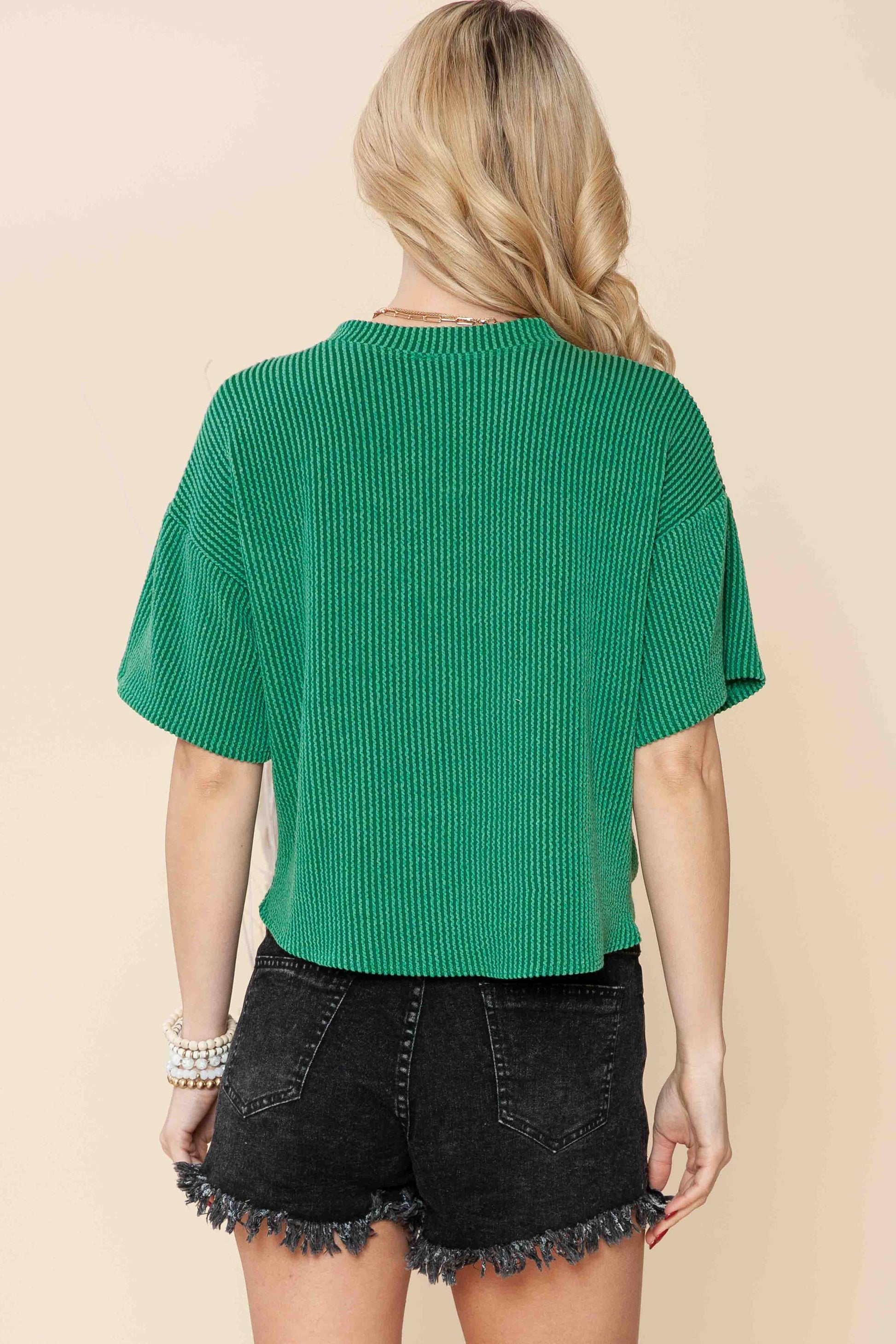 back view of Sage wave rib short sleeve crop top with a front tie and pocket, made from supersoft material, offering a loose fit and vibrant look.