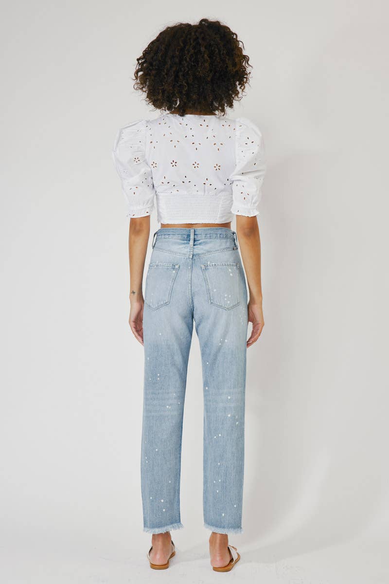 back view of High Rise Slim Straight Jeans in Medium Stone Wash, featuring a 12" rise, 28" inseam, rigid 100% cotton fabric, frayed hem, paint splatter accents, and distressed details with a zip fly.