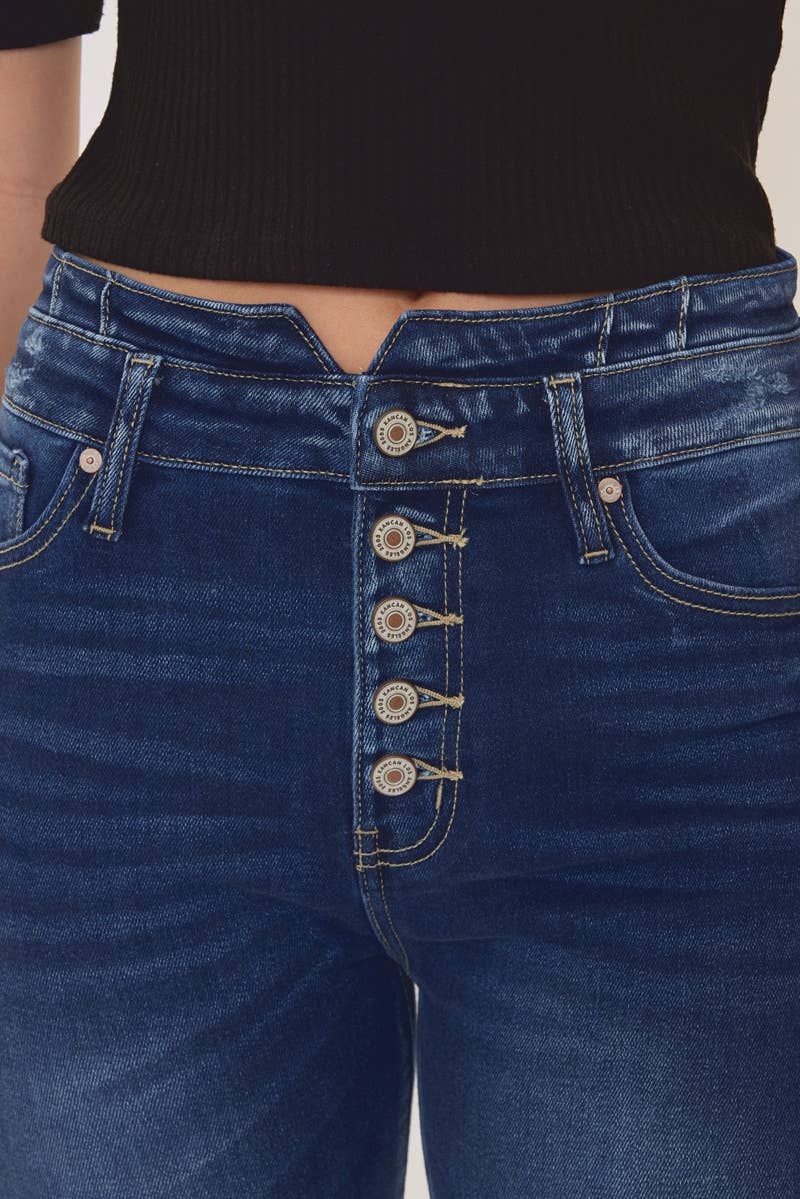 close up front detailed view of Kan Can High Rise WB Detail Curvy Flare Jeans in Dark Stone Wash with comfort stretch fabric, button fly, and non-distressed open pack flare design. Features an 11" rise and 33" inseam, made from 95% cotton, 4% polyester, and 1% Lycra.