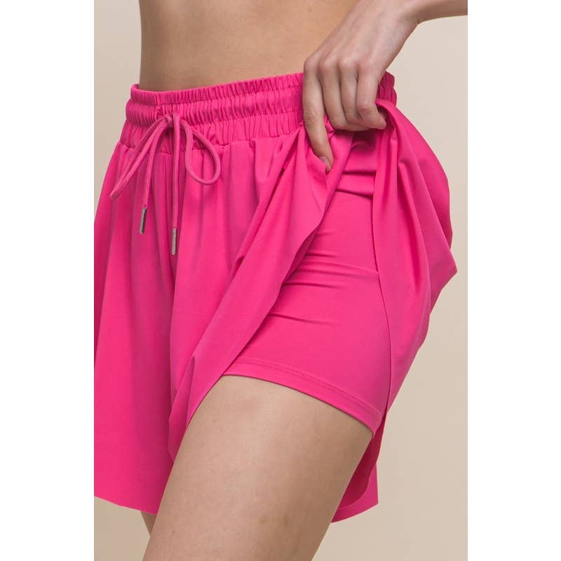 pink view of detailing Activewear Two In One Drawstring Shorts made from 84% nylon and 16% spandex, featuring a stylish design and adjustable drawstring for a comfortable fit.