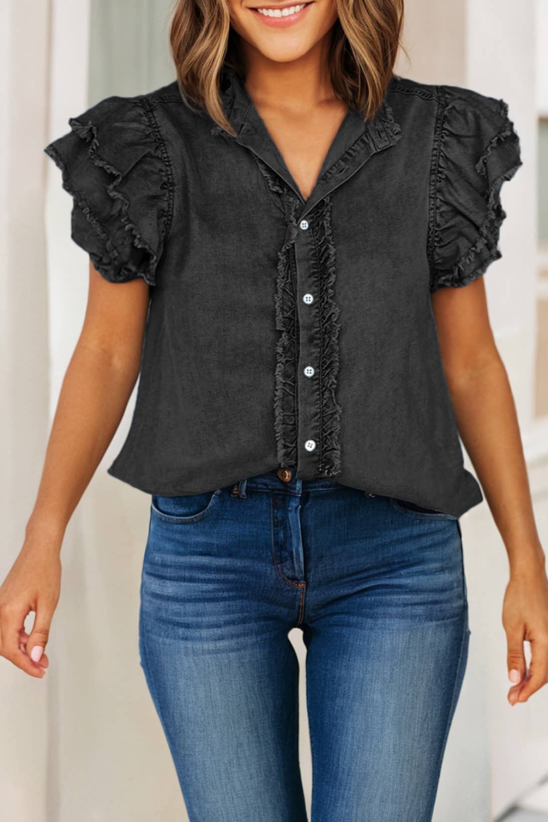 black view of Button front denim blouse with ruffle and flutter sleeves, featuring a frayed hem for a casual and chic look.