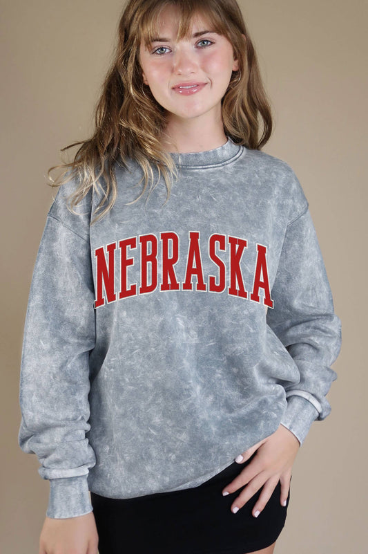 Grey Nebraska Puff Mineral Graphic Sweatshirt with a classic crew neckline, drop shoulder sleeves, and soft, cozy fabric. Features mineral dye variations.