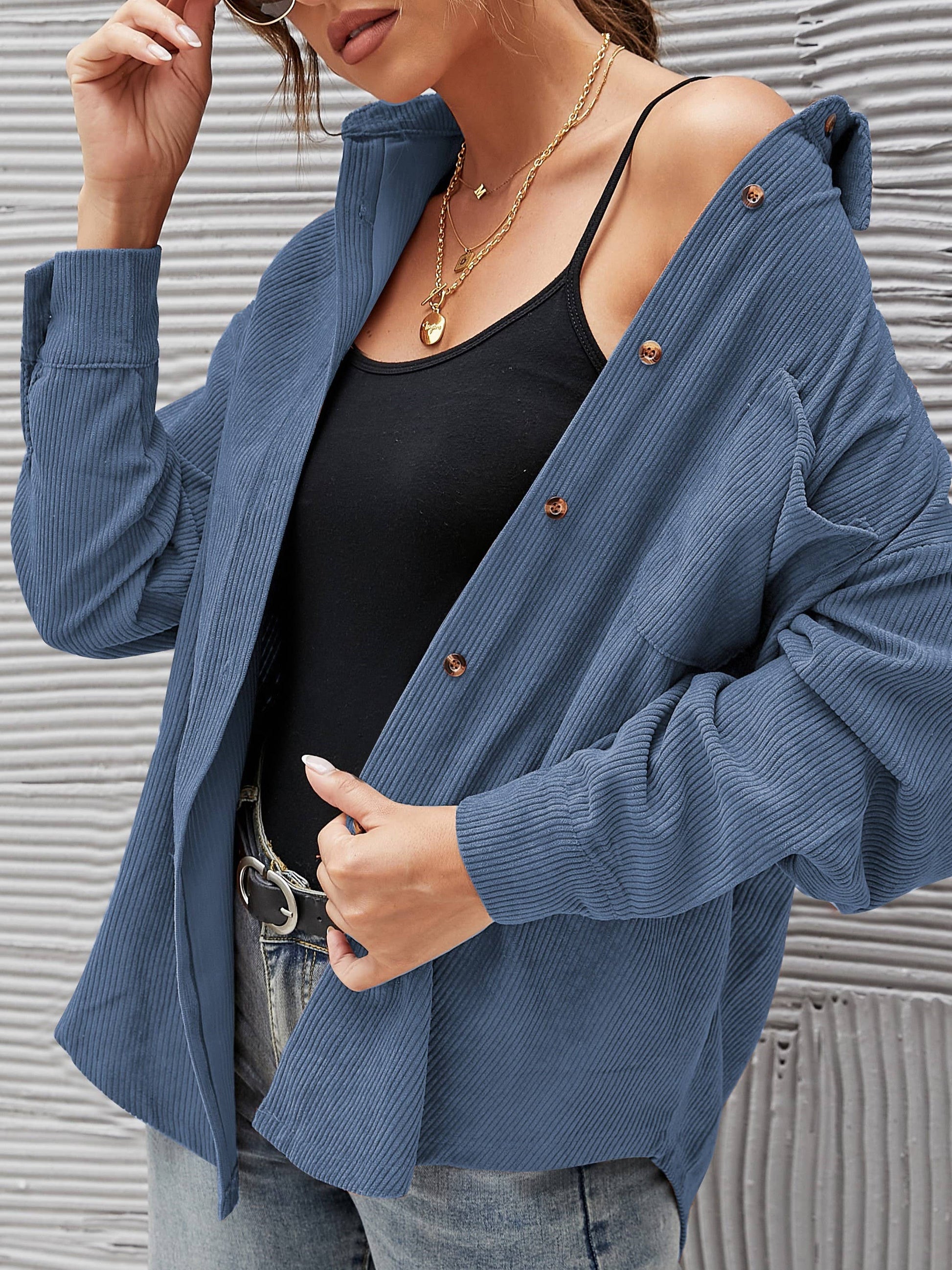 Navy corduroy oversized shacket with a solid design, offering a cozy and stylish oversized fit.