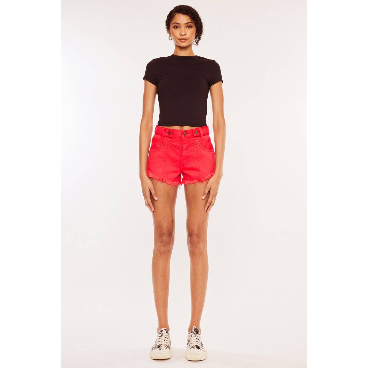 zoomed out front view of Kan Can USA high rise coral red shorts with frayed hem and button accent