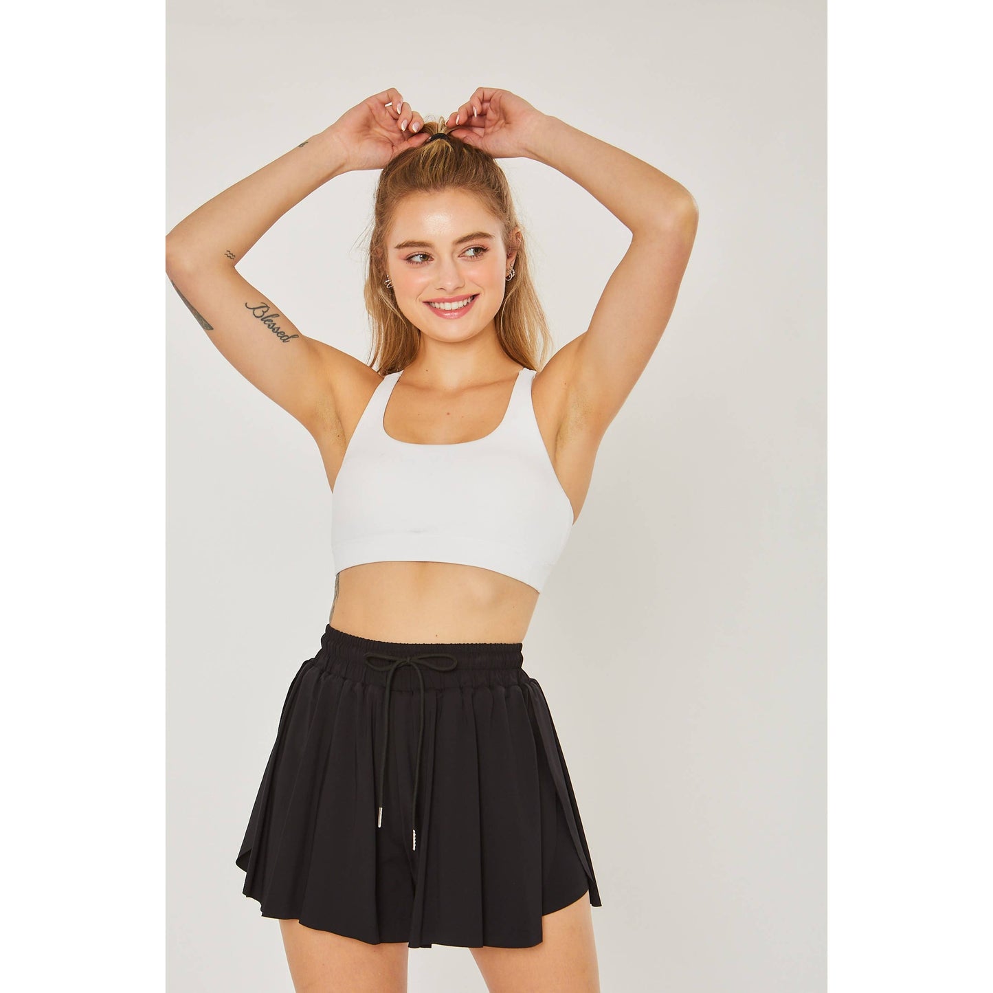 styled view of Activewear Two In One Drawstring Shorts made from 84% nylon and 16% spandex, featuring a stylish design and adjustable drawstring for a comfortable fit.