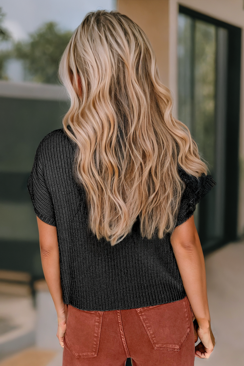 back view of black colored Patch Pocket Ribbed Knit Short Sleeve Sweater in solid pattern, with high neckline and casual style.