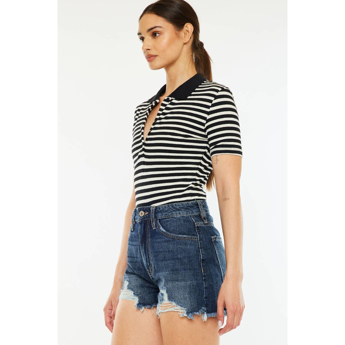 side view of Kan Can USA high rise mom shorts with dark stone wash and raw frayed hem