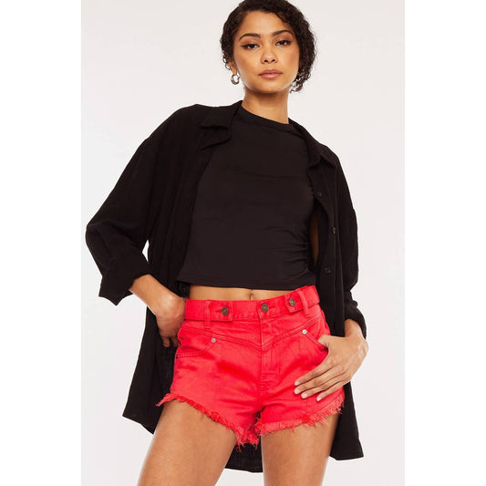 styled view of Kan Can USA high rise coral red shorts with frayed hem and button accent