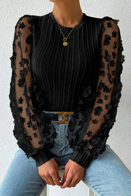 Textured knit blouse with floral applique mesh sleeves, crew neck, and elegant detailing for a chic and sophisticated look.