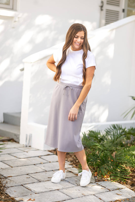 Jordan Coastal Gray Knit Midi Skirt with elastic waist, adjustable drawstring, and kangaroo pockets. Made from a high-quality knit fabric blend.